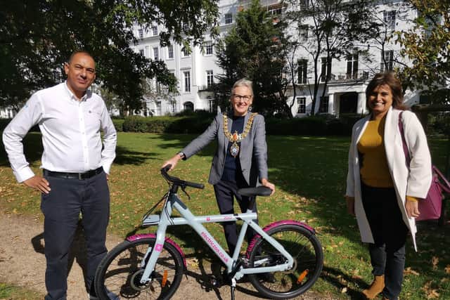 Leamington Mayor Cllr Susan Rasmussen receives her electric bike from Lash Saranna, chief executive officer of Electric Zoo.