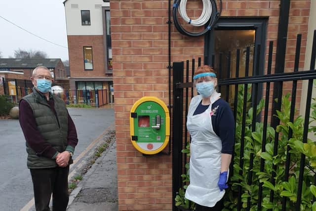 Keith Grierson, Chairman of Kenilworth Heartsafe and Marie Allsopp Castle Brook’s Hotel Services Manager by the defibrillator. Photo supplied