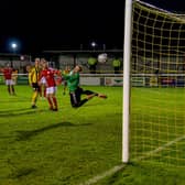 Sam Osborne's superb curling effort beats Brackley Town goalkeeper Danny Lewis to give Leamington the lead in the midweek clash at the Community Stadium. Pictures courtesy of Dean Williams Media