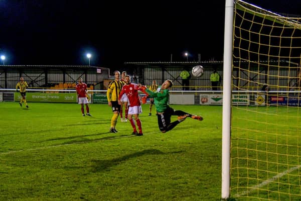 Sam Osborne's superb curling effort beats Brackley Town goalkeeper Danny Lewis to give Leamington the lead in the midweek clash at the Community Stadium. Pictures courtesy of Dean Williams Media
