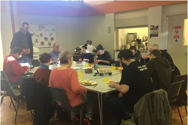 Service users and volunteers sharing a meal at the Way Ahead Project before lockdown. Photo supplied by The Way Ahead Project