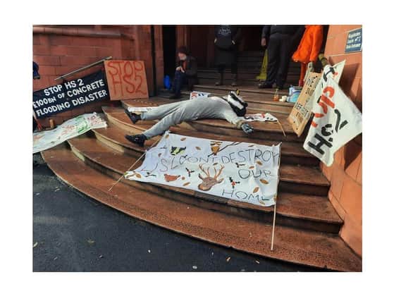 An anti-HS2 protester dressed as a badger plays dead on the steps of Birmingham Magistrates Court.