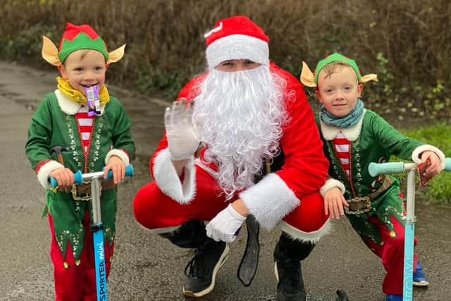 Logan Brittain, five, and his younger brother Jackson, three, donned the festive outfits and joined their dad Daniel, who was dressed as Santa,for the charity challenge braving the rain in the process.