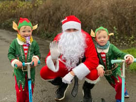 Logan Brittain, five, and his younger brother Jackson, three, donned the festive outfits and joined their dad Daniel, who was dressed as Santa,for the charity challenge braving the rain in the process.