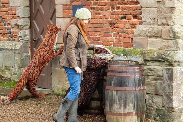 Rachel Harwood with her Willow Sculptures at Charlecote Park. Photo by Jana Eastwood