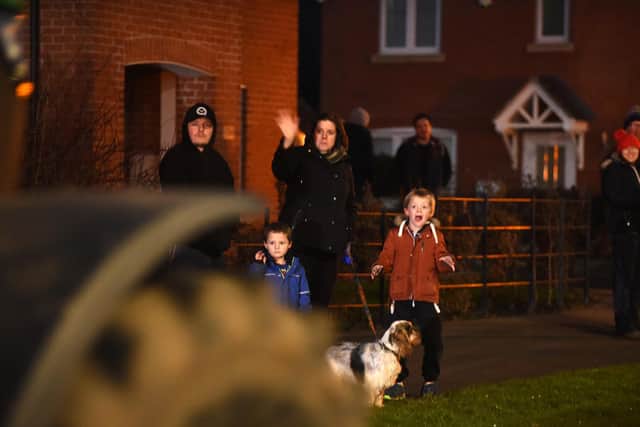 Residents watch the Archers Festive tractor run along Bill Crane Way in Lutterworth.
PICTURE: ANDREW CARPENTER