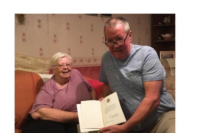 Albert and Lucy Carter with their card from the Queen to mark their Diamond Wedding Anniversary.