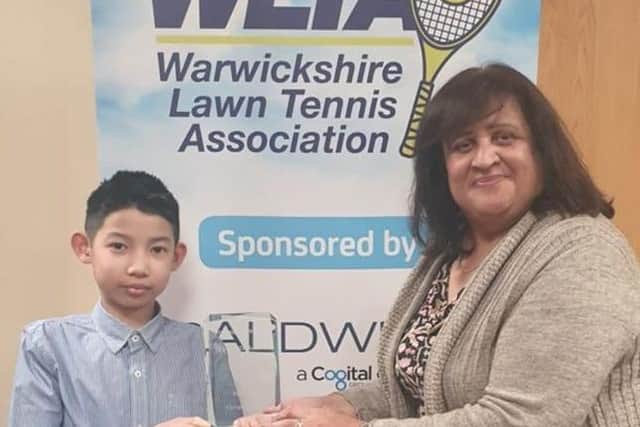 .Ferran Redza, who had the idea for the fundraising run, is shown receiving his Warwickshire Junior Player of the Year award earlier this year from Sue Chopra of Warwickshire LTA.