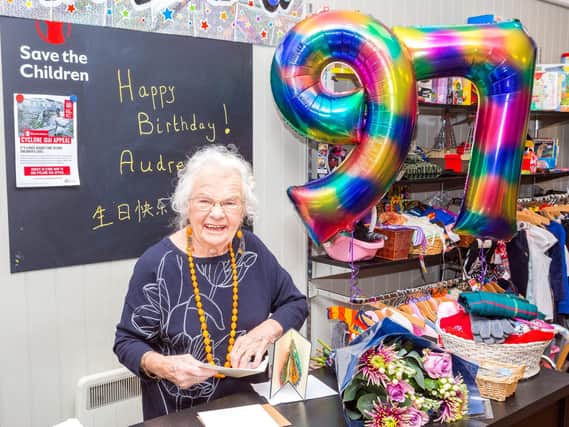 Audrey Gerrans celebrating her 97th birthday at the Save the Children charity shop, where she volunteered on Thursday afternoons.