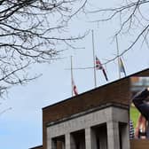 Rugby's flags at half-mast and, inset, Captain Sir Tom.