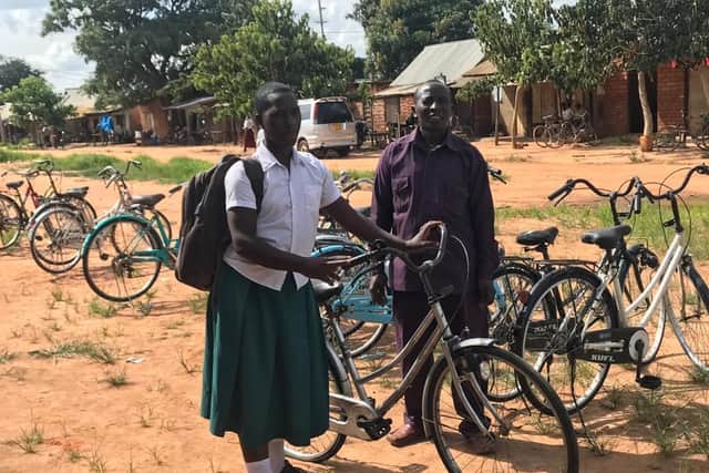 Mr Owden Mwakanema, Uyogo Chairman, allocating a bike to a schoolgirl.