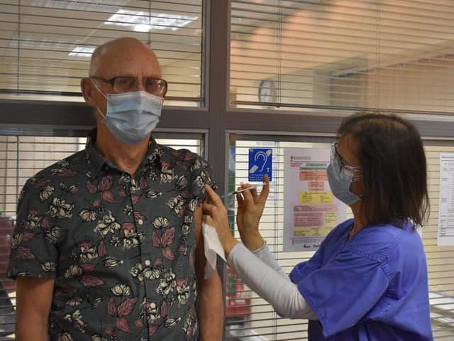 An historical moment - Dr Helen Douse administers the vaccine to her father Dr Joe Douse.