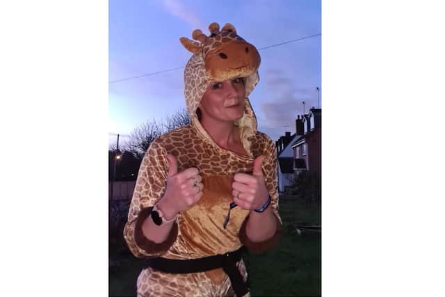 Natalie Faulkner wears a giraffe costume as part of her Miles for Mind scheme last month - raising money and awareness for the charity Mind.