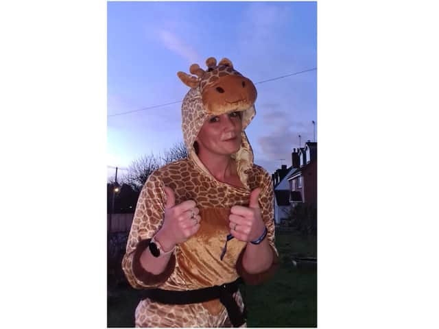 Natalie Faulkner wears a giraffe costume as part of her Miles for Mind scheme last month - raising money and awareness for the charity Mind.