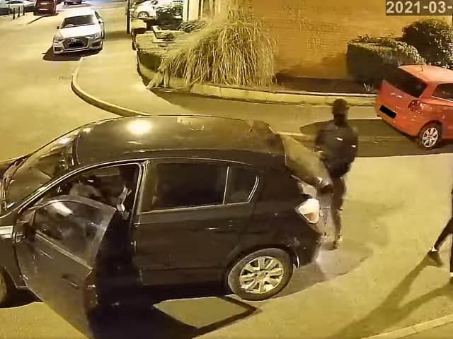 CCTV of the thieves in their black Vauxhall Astra.