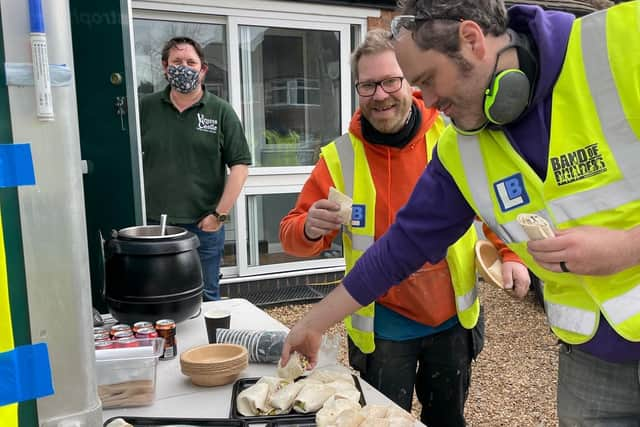 Band of Builders volunteers enjoying lunch served by the Virgins & Castle Team.