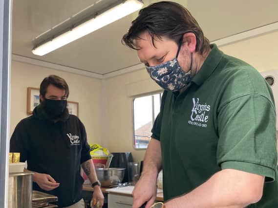 Jonathan Carter-Morris (L), with Andy Lock, general manager of the Virgins & Castle, preparing food for Band of Builders volunteers.