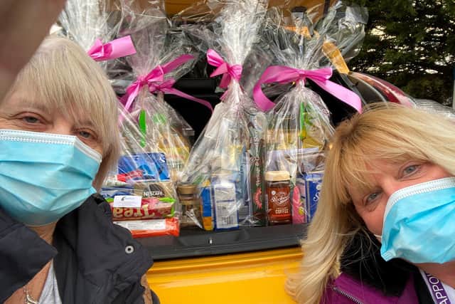 Julie Earls and Di Loxston of Appoint Us Services with some of the hampers. Photo supplied