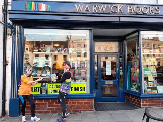 Sue Martin and Pippa White at the end of day five of the bookrun relay,outside the parkrun-themed window display at Warwick Books. Photo supplied