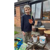 Thomas, one of the Beavers, encouraged other Beavers, Cubs, Scouts and neighbours to decorate plant pots, he then filled them with compost and an iris bulb, and had enough to give one to each resident at Galanos house. Photo supplied