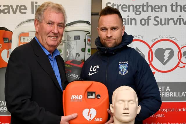 Rugby Town director Mike Yeats and Academy Manager Liam O'Neill with the new defibrillator