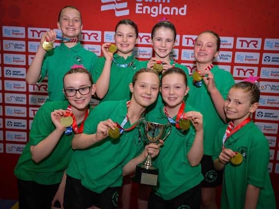 National champions, Rugby Swimming Club Synchros 12 & Under Free Team  with their gold medals and trophy
