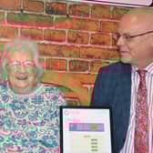 Resident Iris Elliot (centre) admires Castle Brooks good rating with acting general manager Philip Rainsford (right) and hostess Tracey Toogood (left).