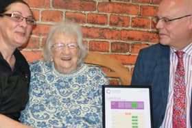 Resident Iris Elliot (centre) admires Castle Brooks good rating with acting general manager Philip Rainsford (right) and hostess Tracey Toogood (left).