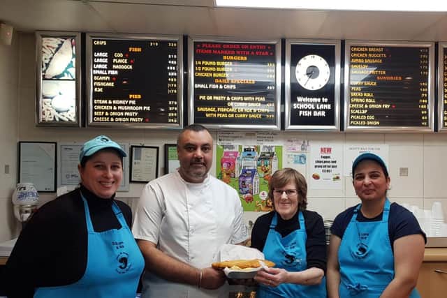 Colin Kandola with Pat Barker (second right) with members of the team at the fish and chip shop. Photo supplied.