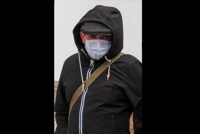 Neil Rylance wears a surgical mask outside court - before removing it completely to light a cigarette.