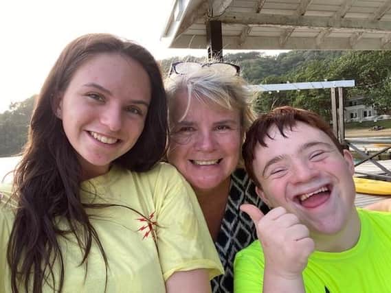 The Ups of Downs charity founder Nicola Enoch (centre) with her daughter Emily and son Tom.
