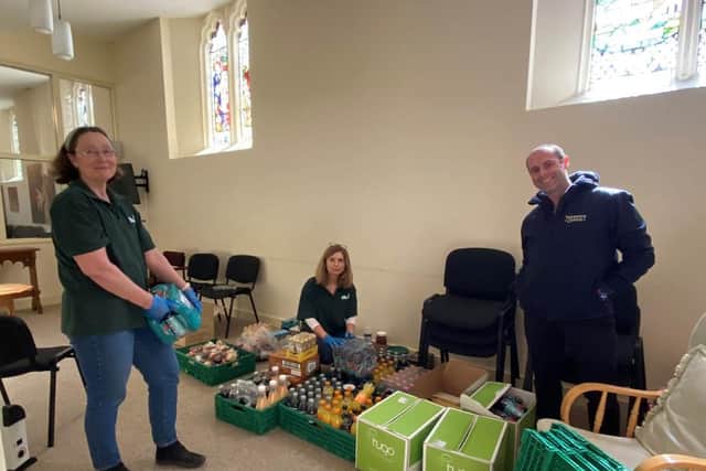 Team members at Warwick Food Bank receive a food donation from Matt Harrison, Kitchen Manager at Warwick Castle. Photo supplied