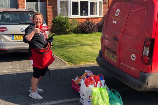 Postwoman Sandy Storer receives the items from residents of Jourdain Park and Bagot Way in Leamington.