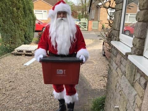 Phil Web taking the bins out dressed as Father Christmas. Photo supplied