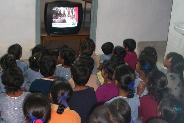 Children watching a DVD. Photo by Education Saves Lives