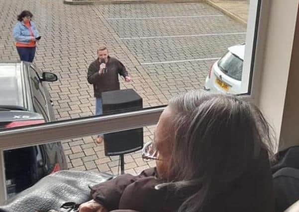 Alan Baylistook it up on himself to sing to residents at Cherry Tree Cherry Tree Lodge while they watched from their windows.