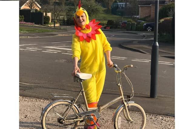 Rachel Turner has been bringing some happiness to her customers by delivering CDs, stickers and colouring in a chicken suit, during her daily exercise by bike.