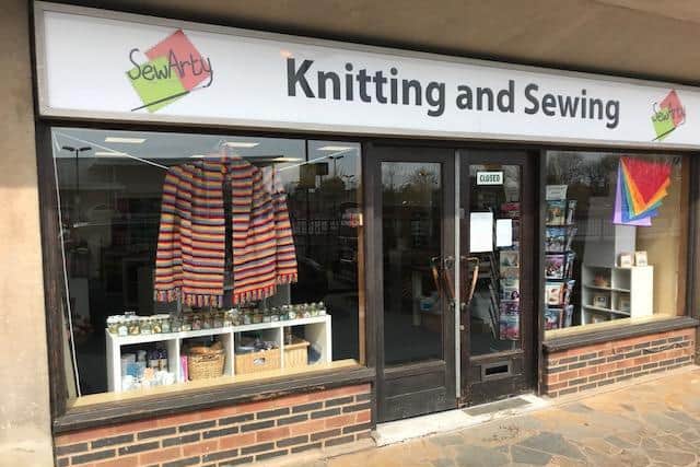 The rainbow prayer shawl in the window of SewArty Knitting and Sewing in Kenilworth.