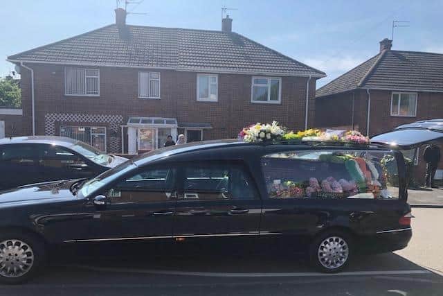 The hearse which carried Joy Barry's body to Leamington Cemetary parked outside the family's home in Lillington where neighbours came out of their homes during lockdown to pay their respects.