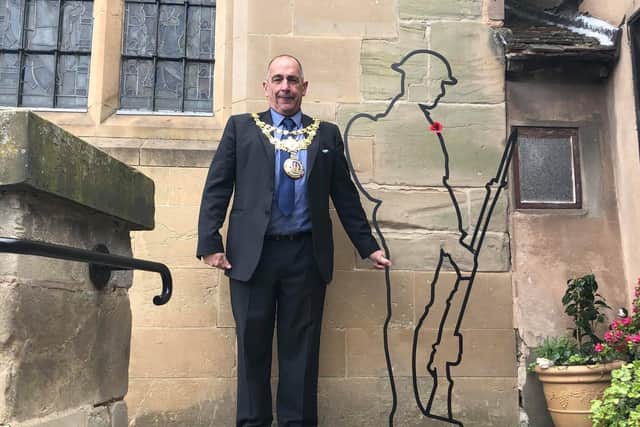 The Mayor of Warwick Cllr Neale Murphy standing with the Tommy at the Lord Leycester Hospital. Photo supplied.