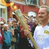 Peter Frazier carrying the Olympic Torch in Leamington in 2012