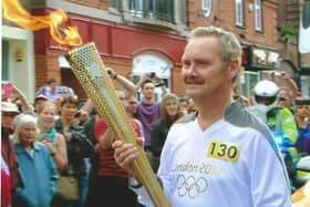 Peter Frazier carrying the Olympic Torch in Leamington in 2012
