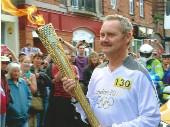 Peter Frazier carrying the Olympic Torch in Leamington in 2012