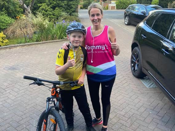 Natalie Casey and her son Jack who cycled alongside her while she ran the half marathon in memory of her twin daughters and to support the baby charity Tommy's.