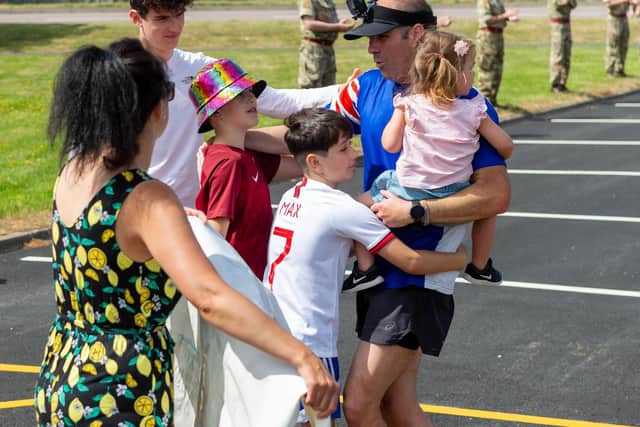 Warrant Officer Class Two (WO2) Si Hannaford crosses the line, into the waiting arms of his family.
Photo by Cpl Paul Watson RLC Photographer, Crown Copyright 2020.