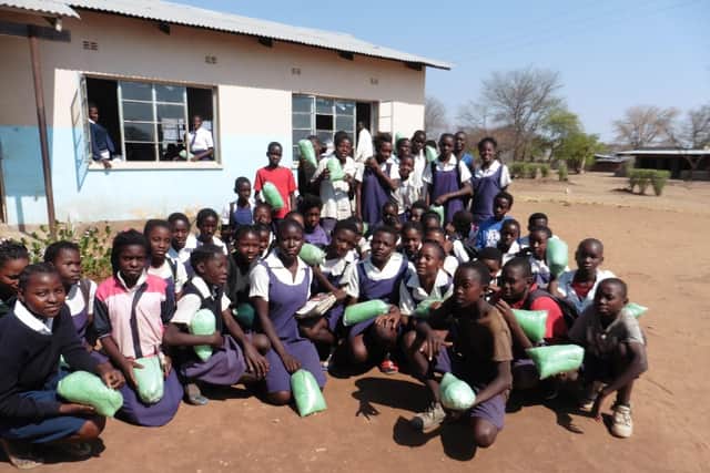 Children at Mambova Primary School, Kazungula, Zambia, each with their insecticide-treated mosquito nets donated by RC Royal Leamington Spa as part of the Mosquito Nets for Schools Programme initiated by local charity The Butterfly Tree.
