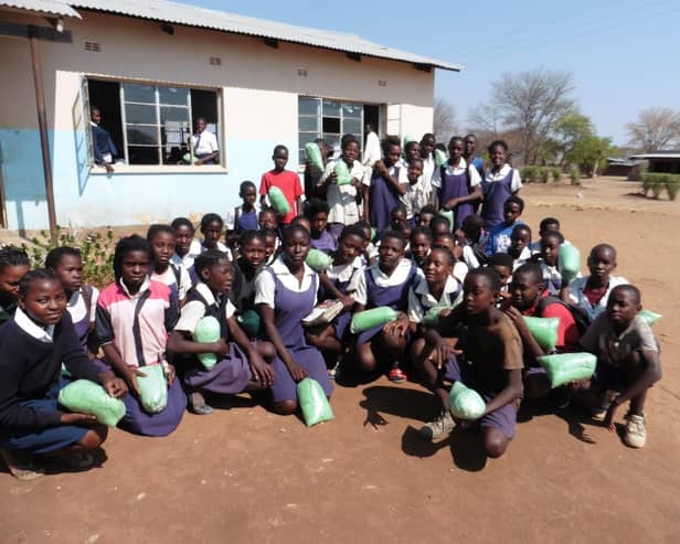 Children at Mambova Primary School, Kazungula, Zambia, each with their insecticide-treated mosquito nets donated by RC Royal Leamington Spa as part of the Mosquito Nets for Schools Programme initiated by local charity The Butterfly Tree.