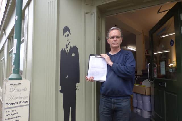 Paul Lamat of Lamat's Hardware with the petition outside the shop in Old Town, Leamington.