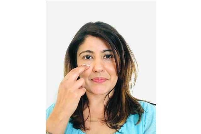 Well-being coach Meeta Darji demonstrating the tapping technique on one of the facial points. Photo supplied