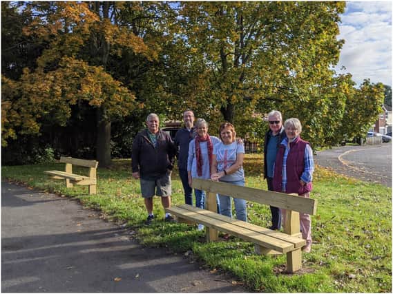Cllr Oliver Jacques and Mary Overton with other residents at one of the new benches. Photo supplied